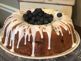 Lemon Bundt cake with glaze and with middle full of blueberrues