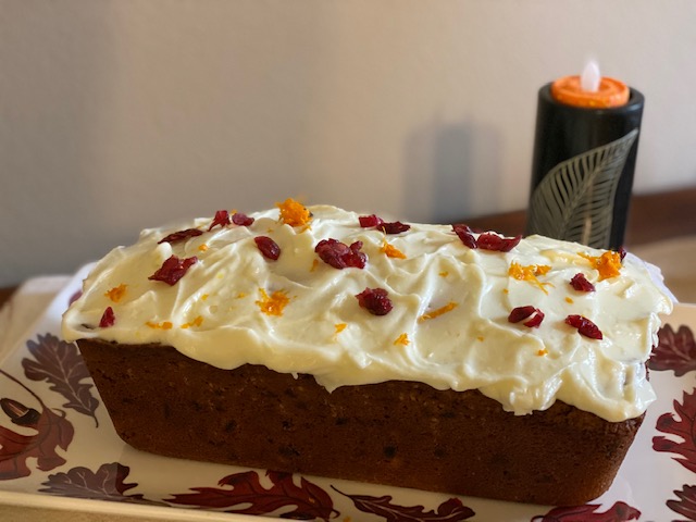 loaf cake with cranberry and orange flavors and cream cheese frosting