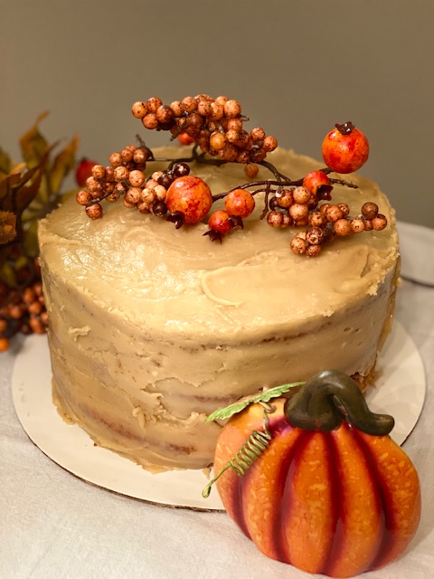 Yellow sour cream cake with caramel icing and thanksgiving decorations