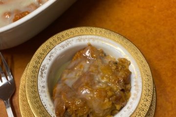 Small serving Pumpkin Bread Pudding in gold a nd white dessert bowl