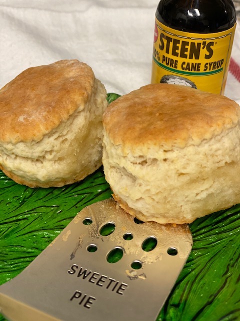 Two fluffy biscuits with bottle Steen syrup