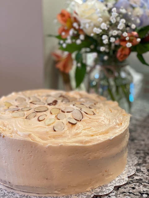Three layer moist yellow cake with apricot filling and buttercream icing
